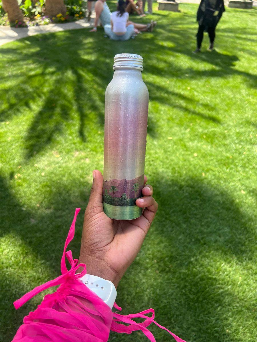 woman holding a reusable water bottle at Coachella
