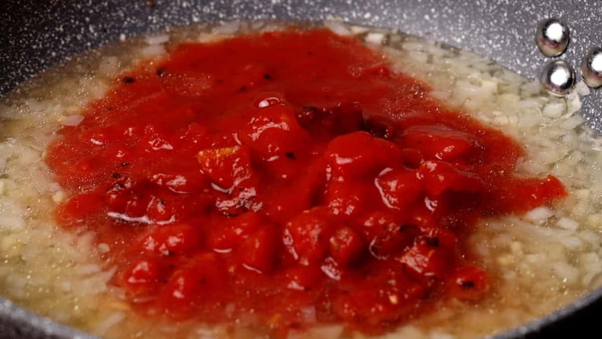 Close-up of Chicken Tinga simmering in a pot
