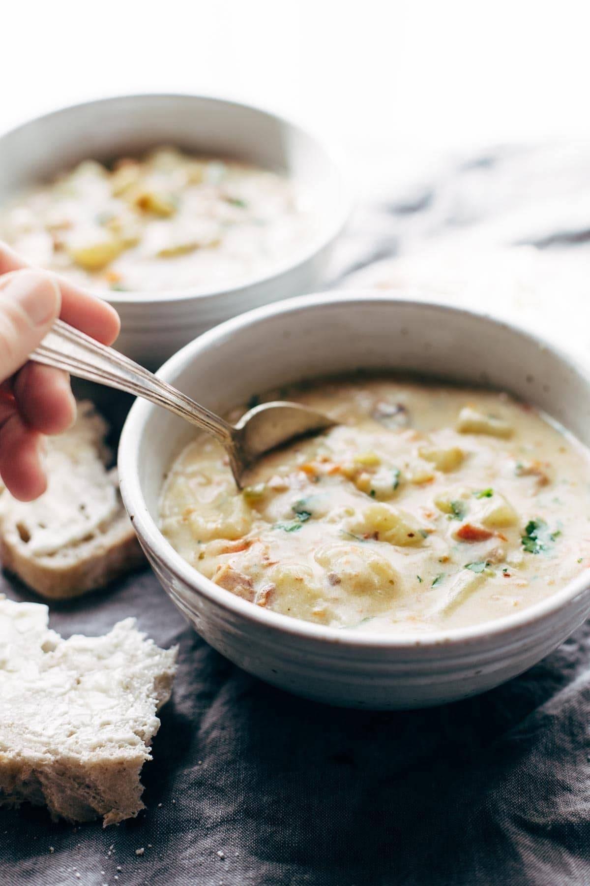 Close-up shot of creamy potato soup being poured into a bowl
