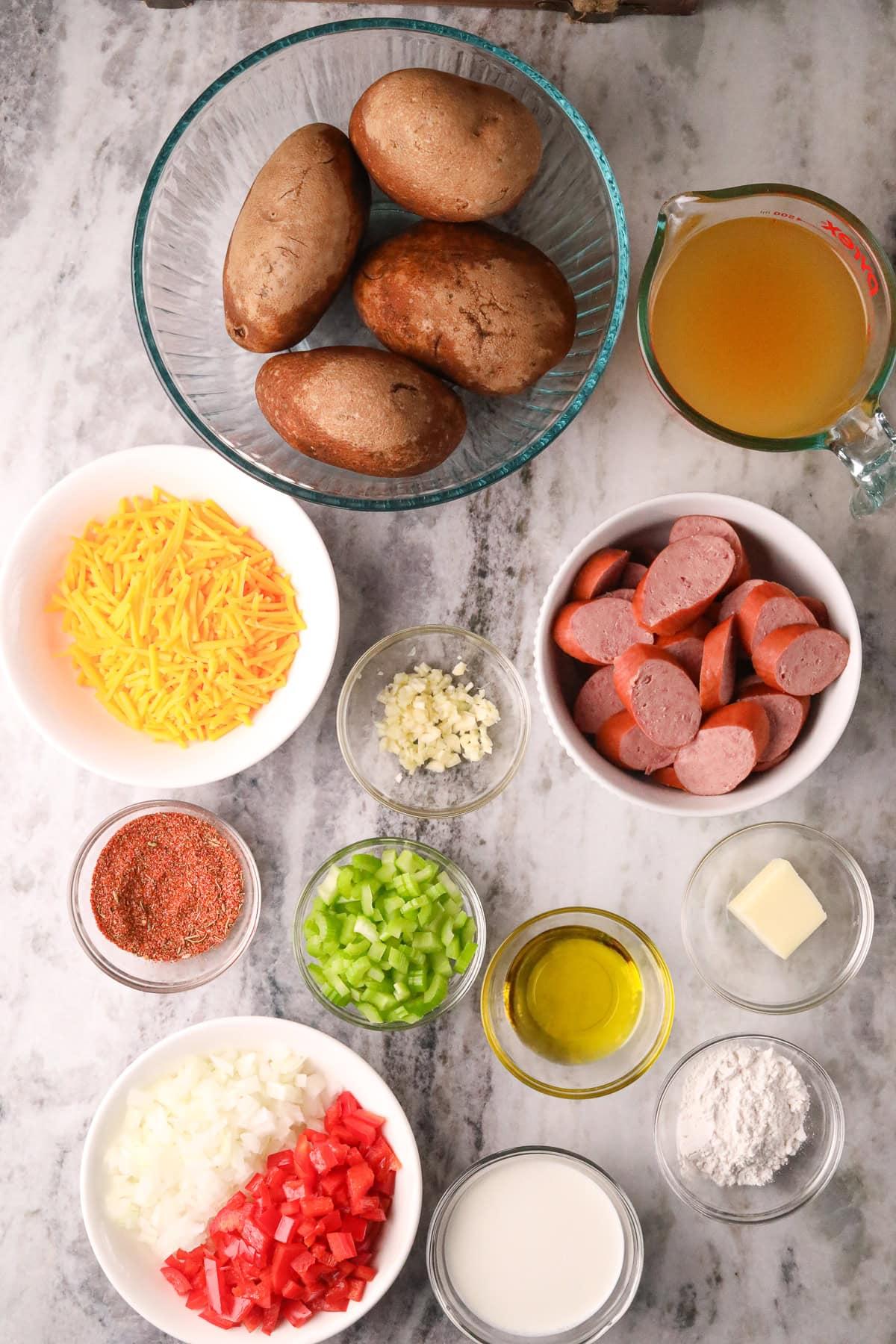 Ingredients for creamy potato soup arranged on a wooden table