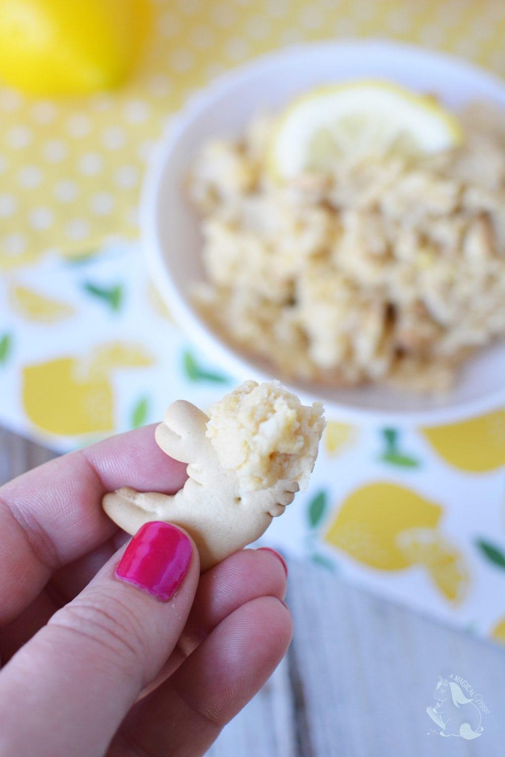 Hands zesting a lemon over a bowl of cookie dough