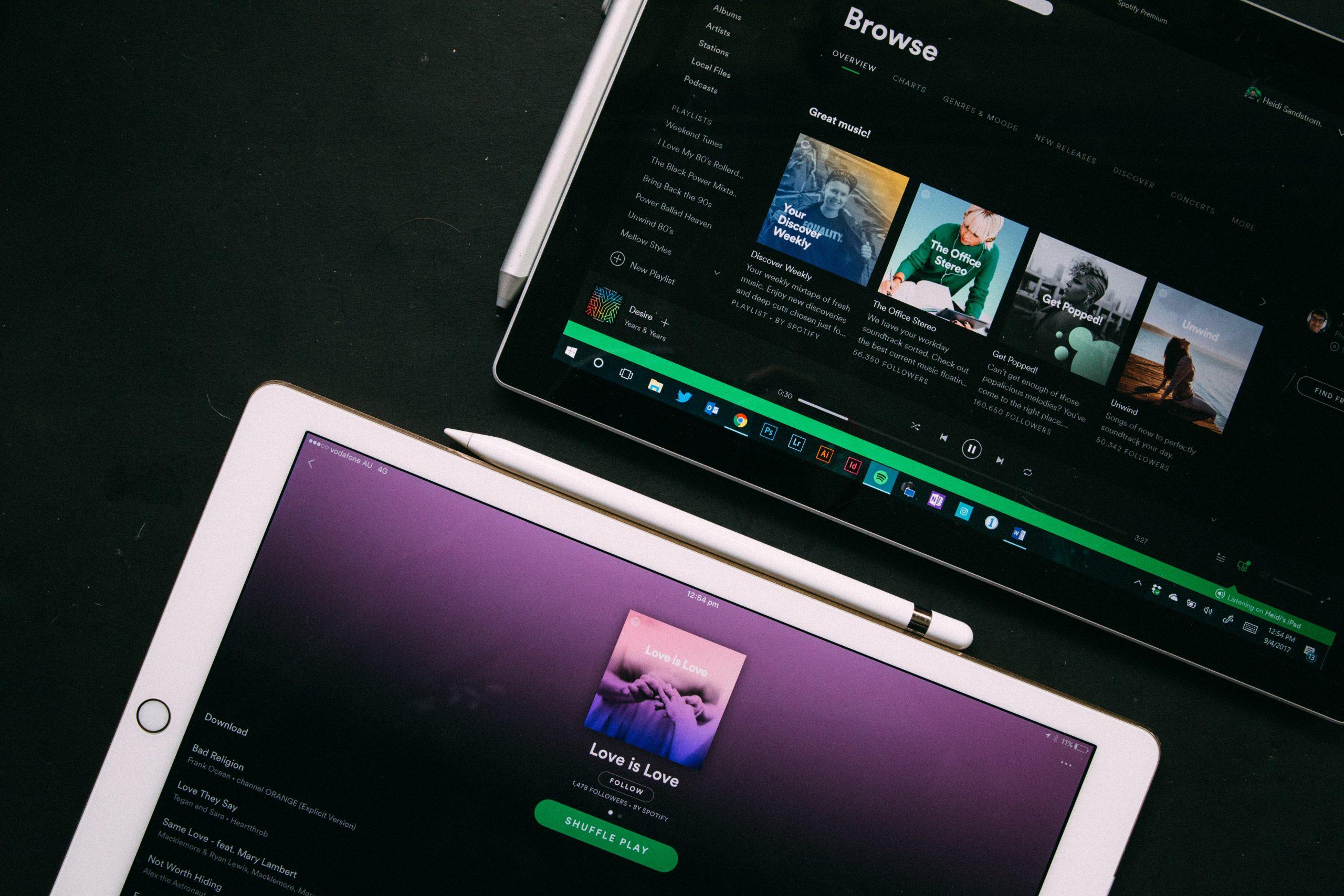 Various summer playlists on a laptop