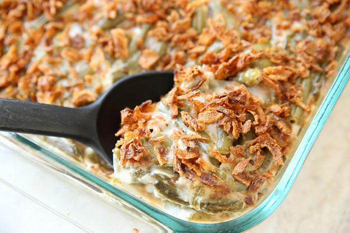 Vintage style close-up of green bean casserole baking in a ceramic dish