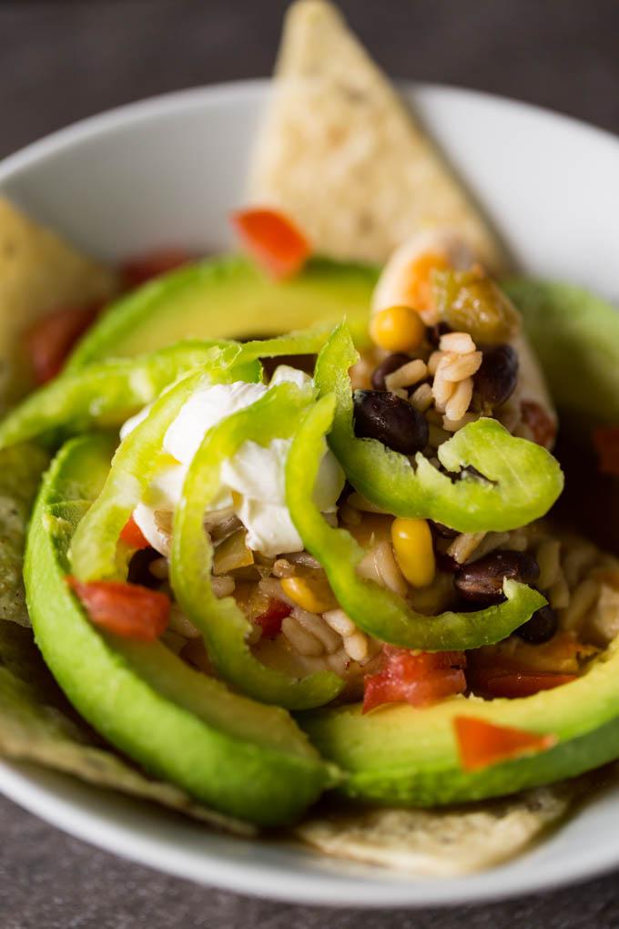 a close-up shot of a chicken taco bowl being assembled