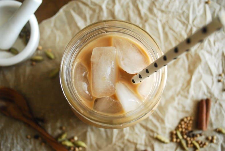 overhead shot of iced chai latte ingredients arranged on a counter