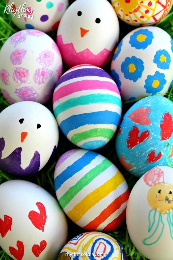 Preschooler decorating eggs with markers