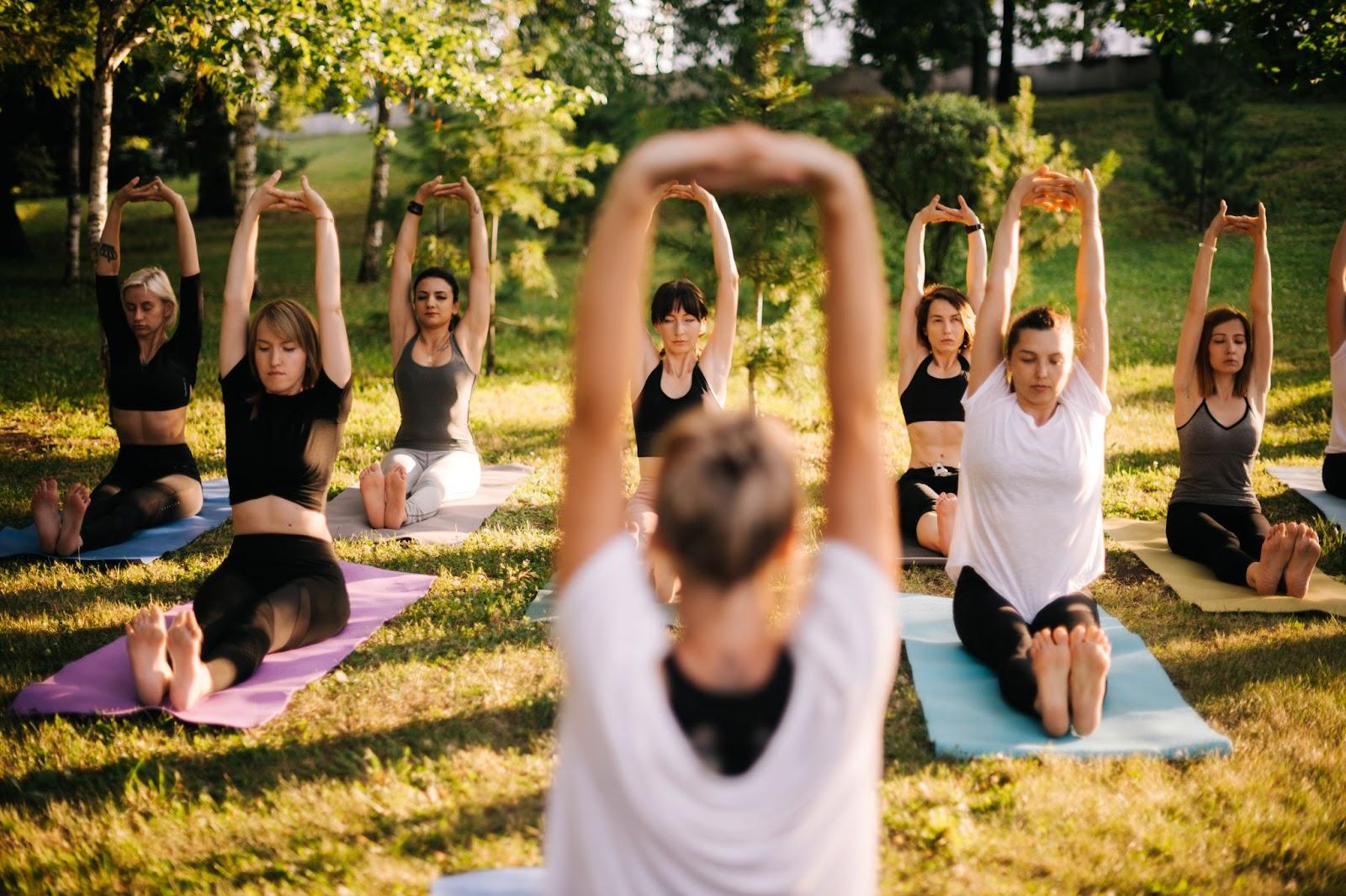 people exercising in a springtime park, jogging, yoga