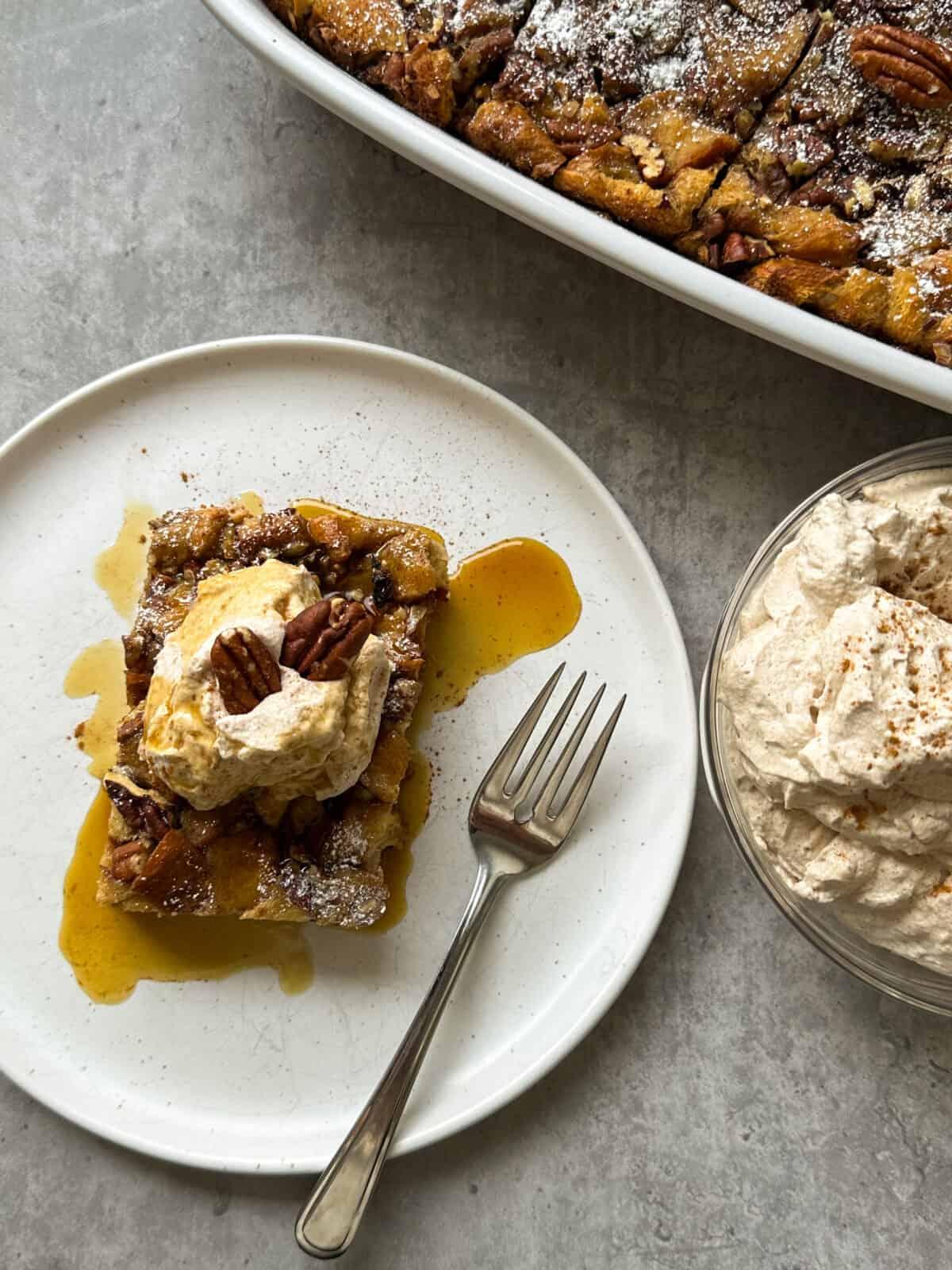 a slice of french toast casserole on a plate with a fork, ready to be eaten