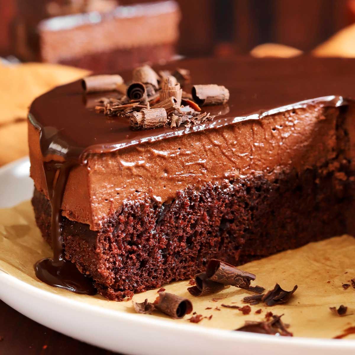 a perfectly sliced truffle oil chocolate cake with visible layers of moist cake and ganache