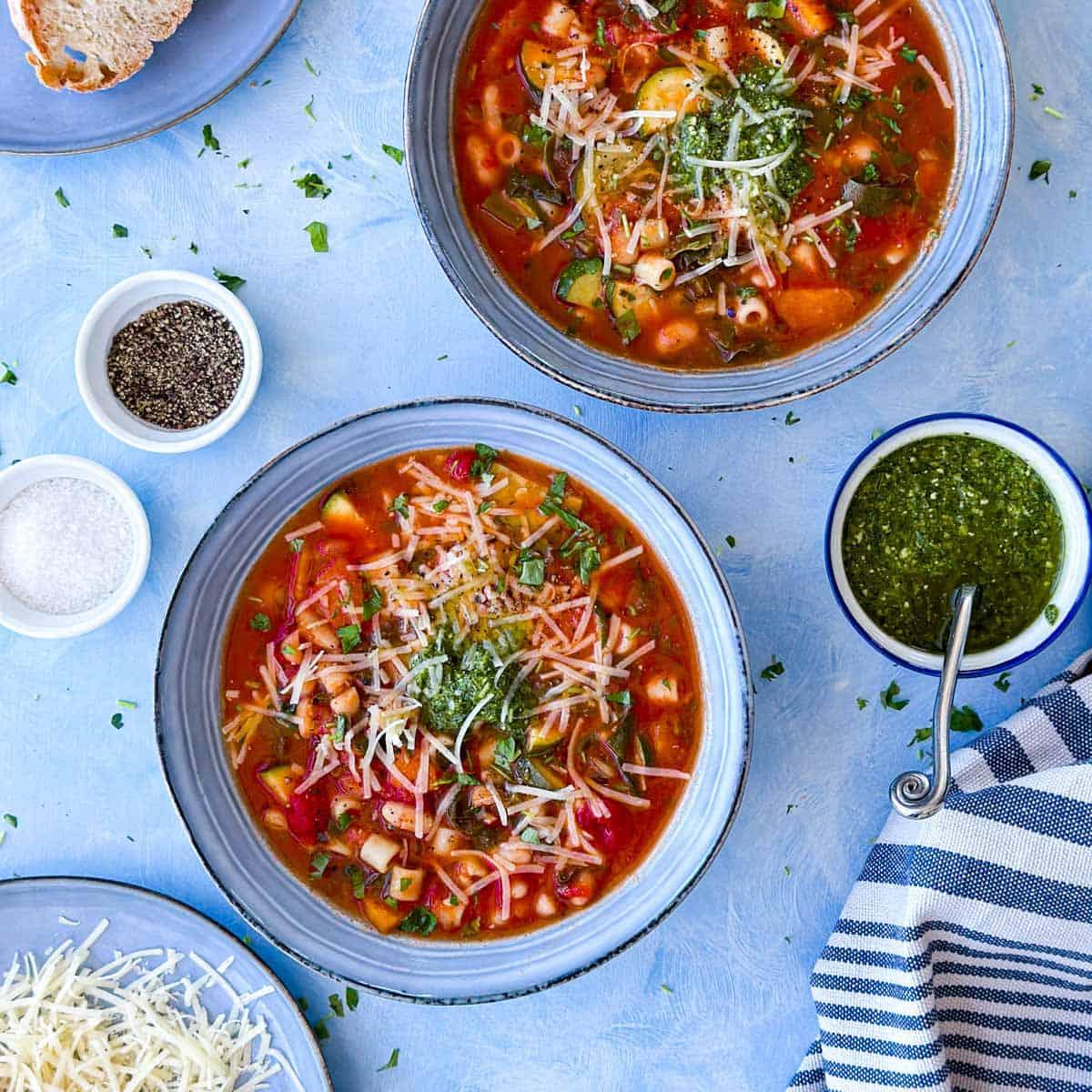 family enjoying bowls of minestrone soup around a table