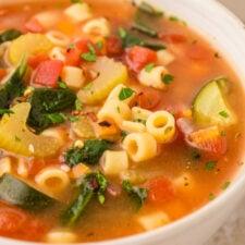 close-up of minestrone soup with visible vegetables and pasta