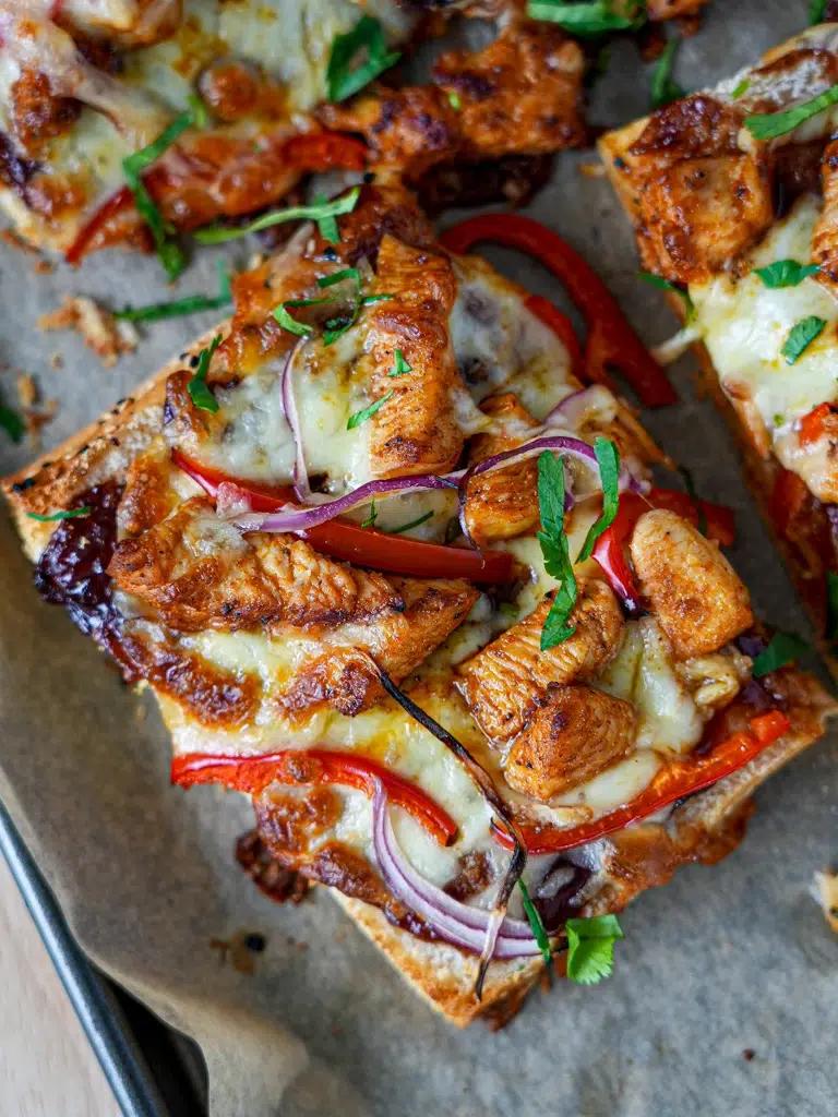 Close-up of the melted cheese and BBQ chicken on the flatbread