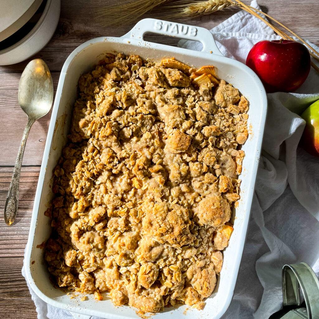 apple pie baked apples with oat crumble on a wooden table