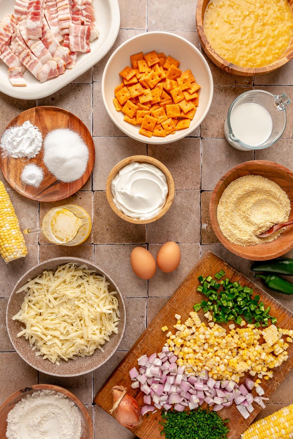 Ingredients for corn casserole laid out on a rustic wooden table
