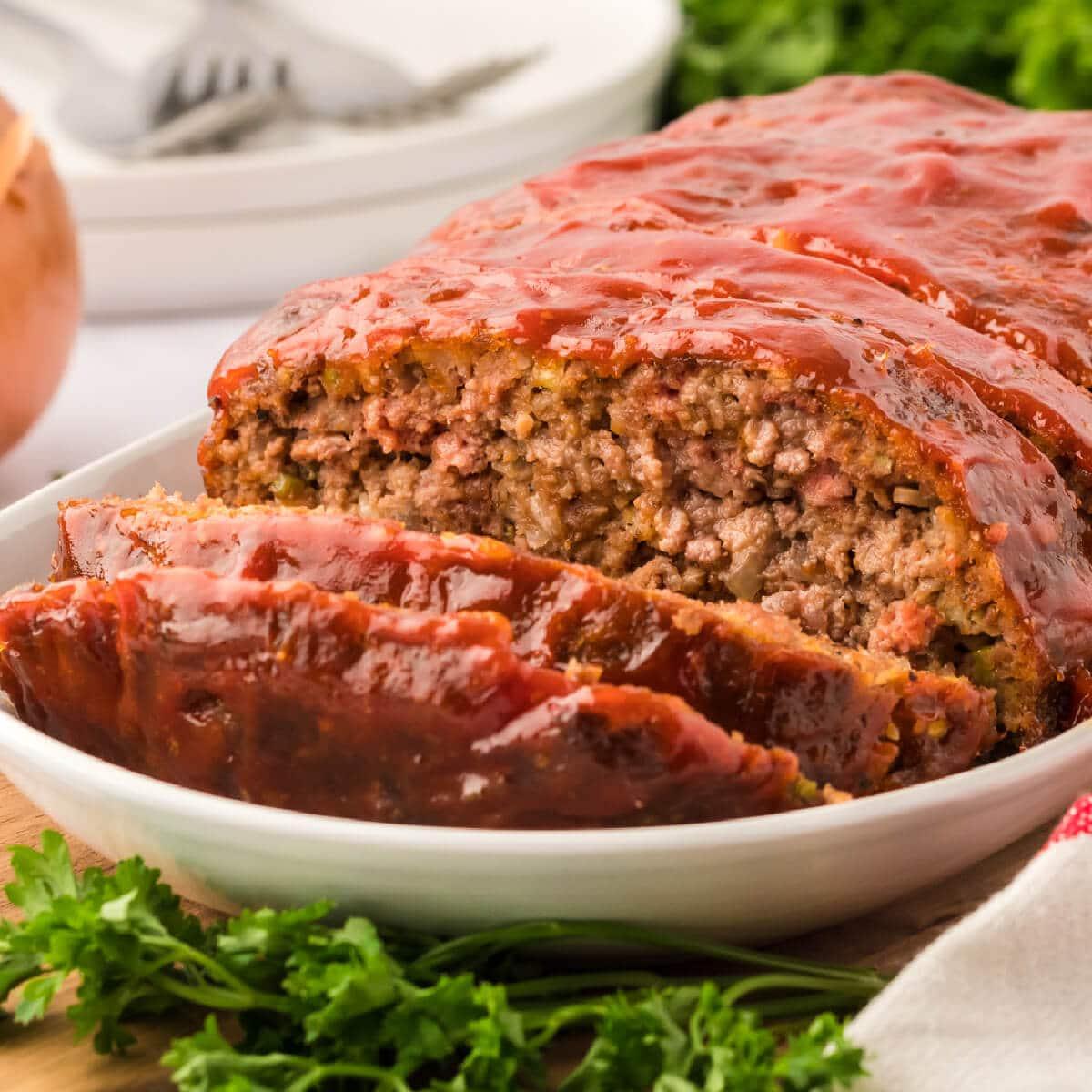 a child helping an adult mix ingredients for meatloaf in a kitchen