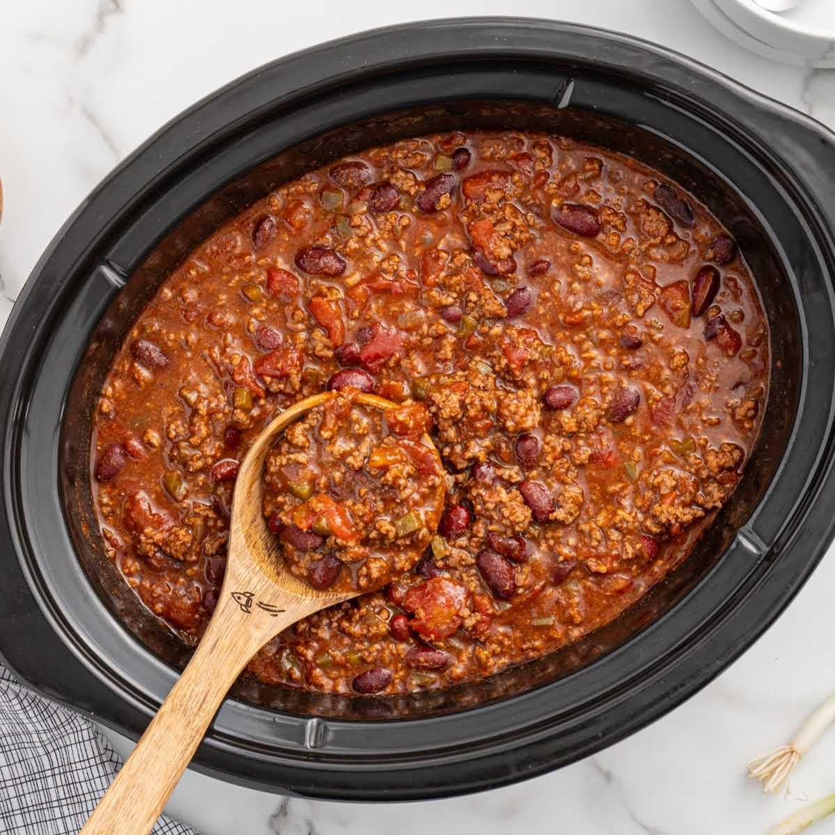 Slow cooker filled with simmering chili
