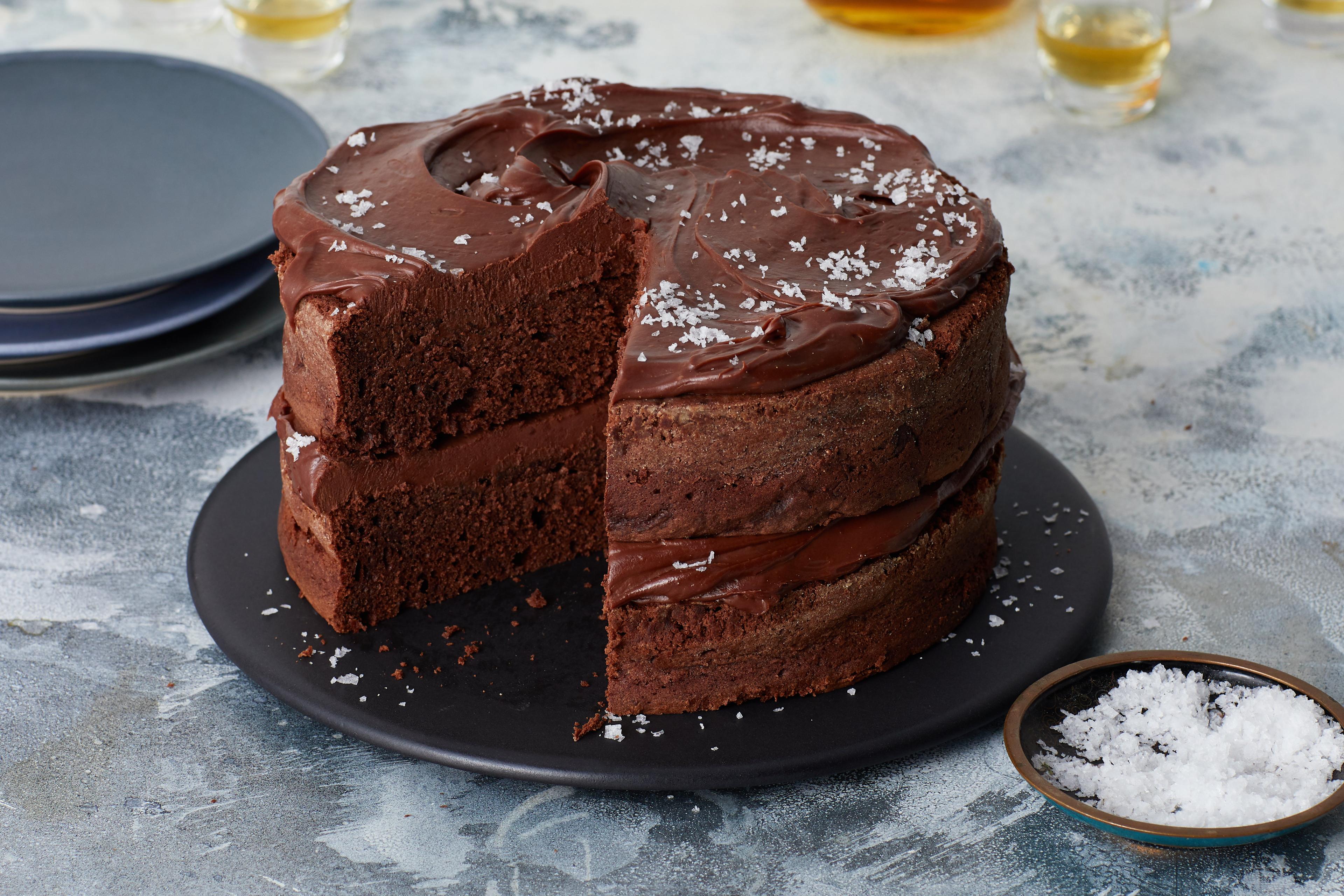 overhead shot of a fully assembled salted chocolate ganache layer cake on a cake stand