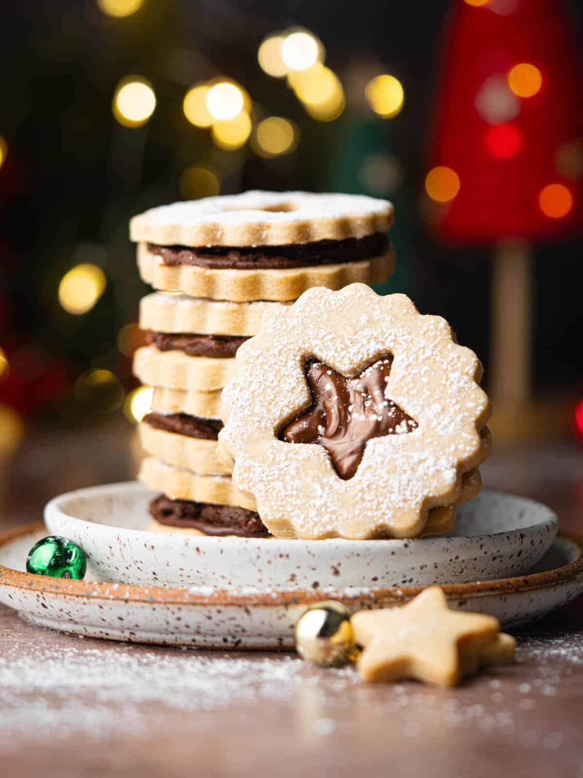 Ingredients for espresso shortbread cookies, including butter, flour, sugar, and espresso powder, laid out on a wooden counter with a vintage coffee grinder
