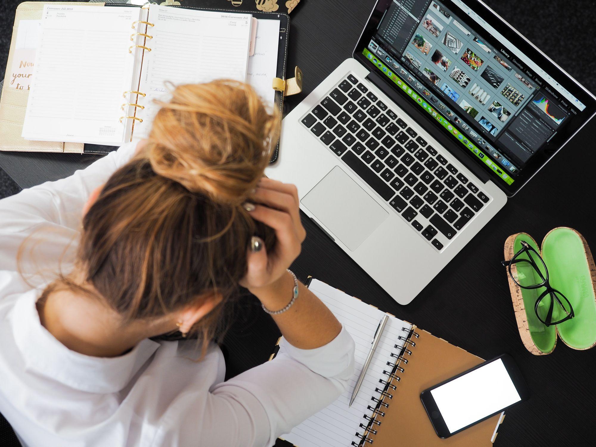 woman creating eye-catching youtube thumbnails on laptop