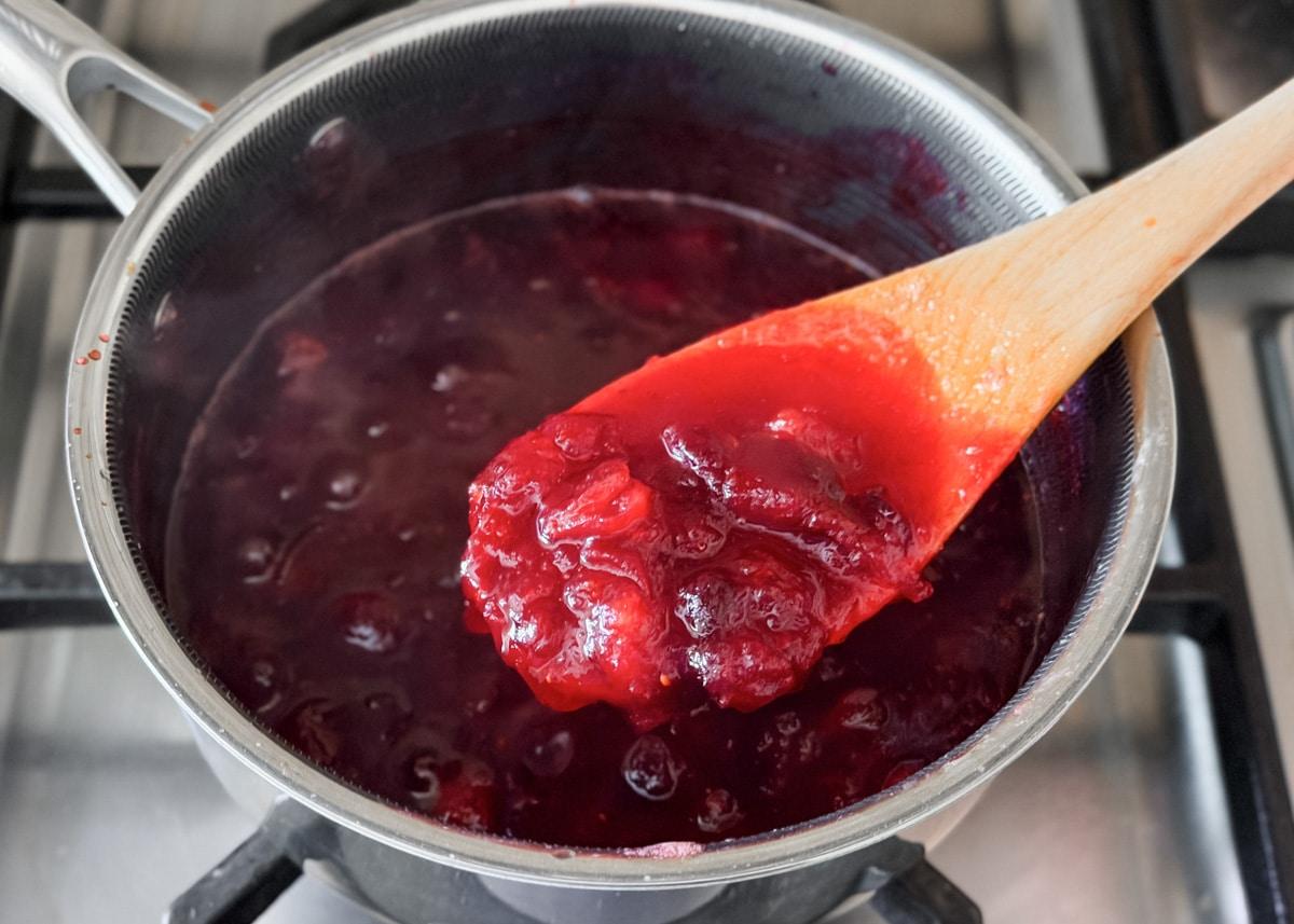 Close-up of cranberry sauce simmering in a saucepan