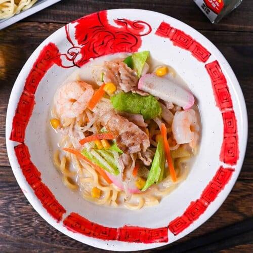 Overhead shot of a steaming bowl of Nagasaki Champon with chopsticks.