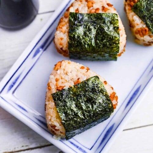 Overhead shot of several Umeboshi and Seaweed Chicken Quinoa Onigiri arranged on a plate