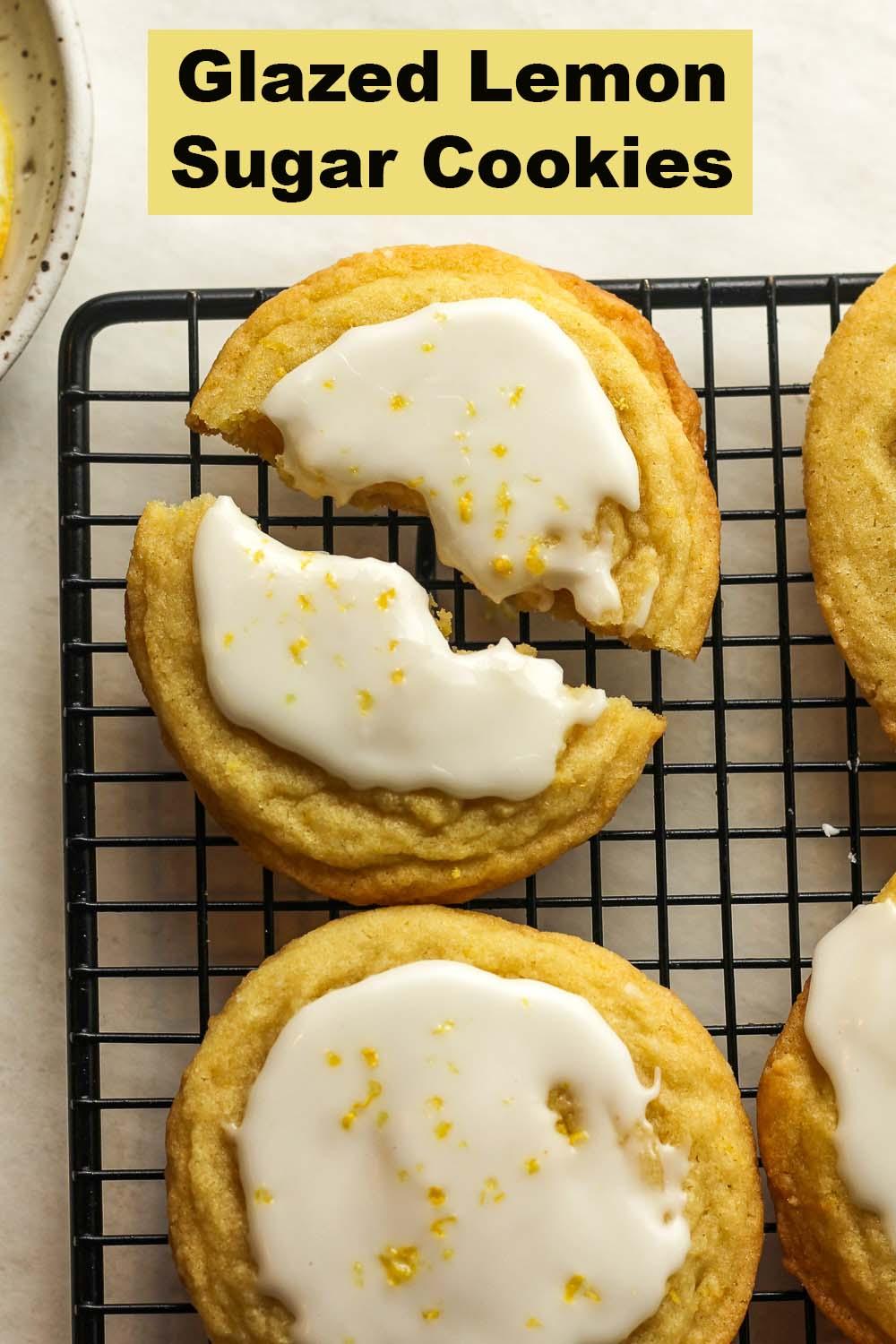 various shapes of lemon glazed sugar cookies arranged artfully on a cooling rack
