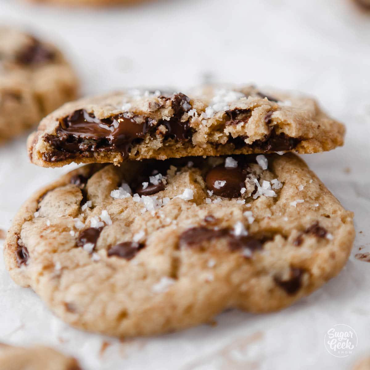close-up shot of a chocolate chip cookie with melted chocolate and sea salt flakes