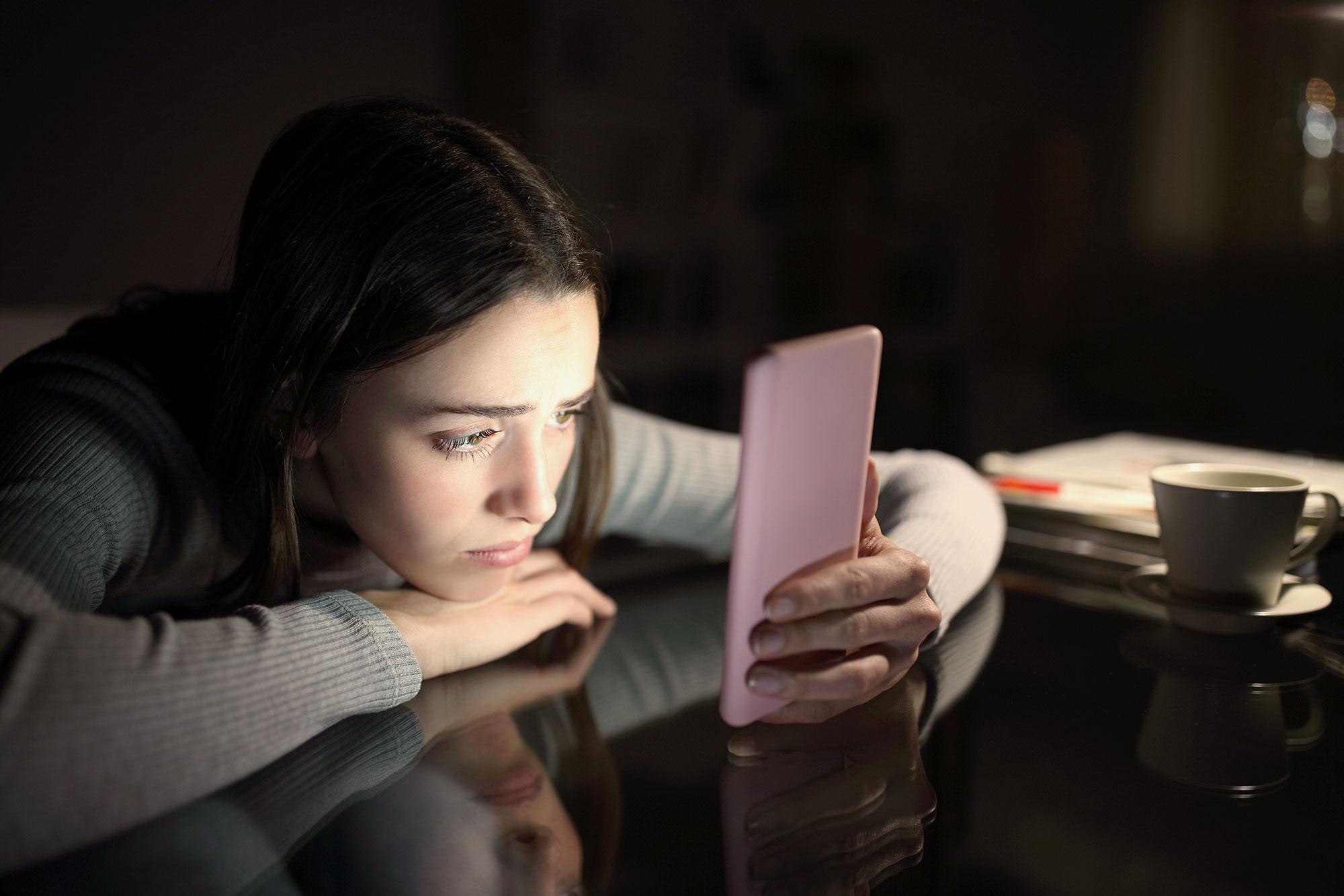 person nervously checking their Instagram on a smartphone