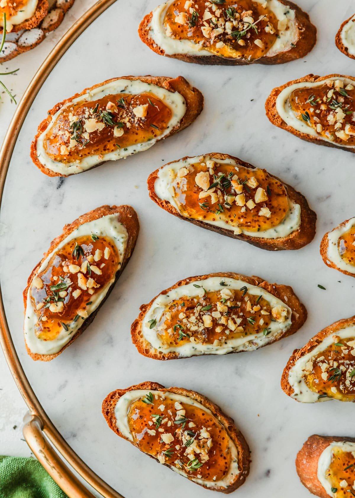 close-up shot of a single goat cheese and fig jam crostini, showcasing the texture and ingredients
