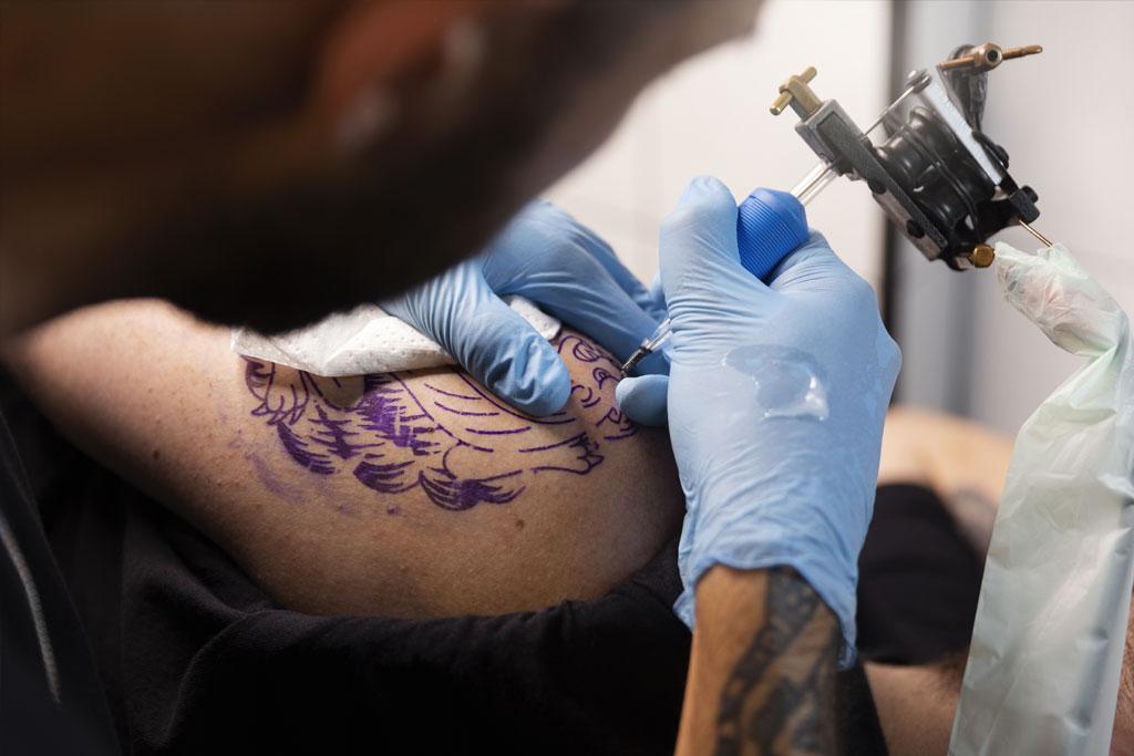 tattoo artist washing hands