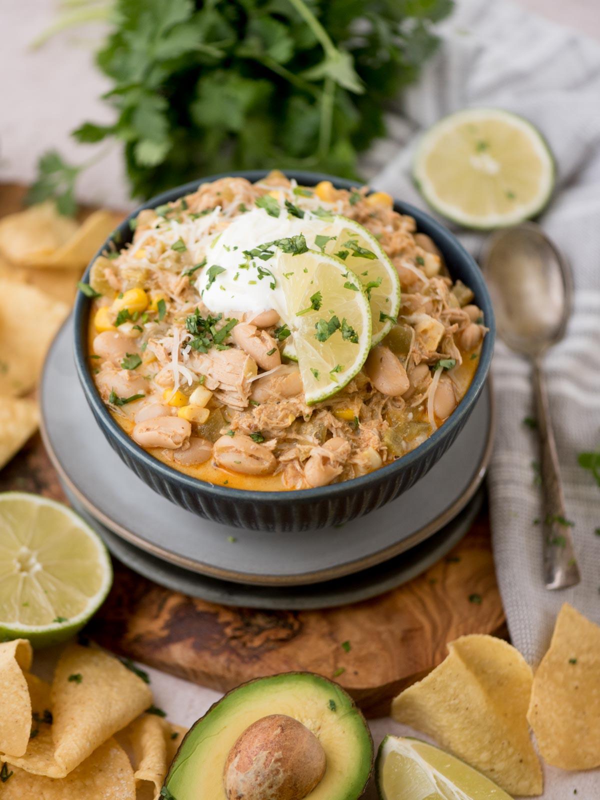 white chicken chili garnished with cilantro, sour cream, and tortilla strips