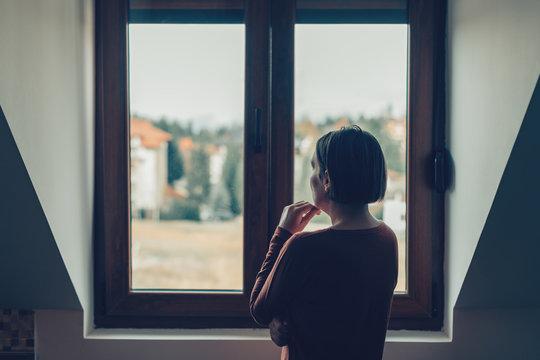 woman looking out the window