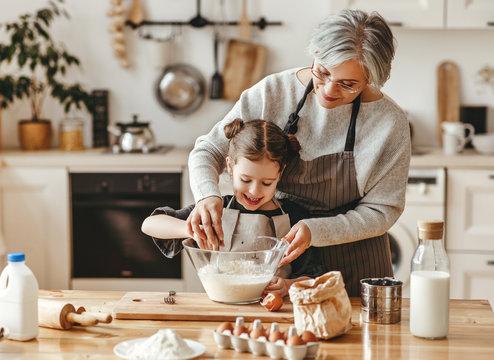 grandmother baking cookies with a child