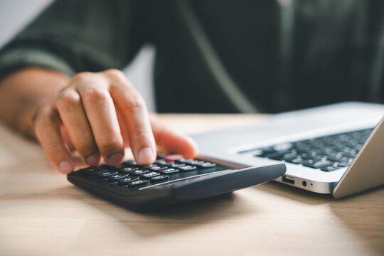 person comparing prices on a calculator