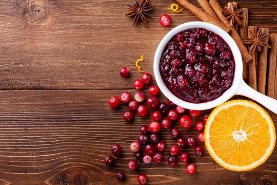 overhead shot of a Thanksgiving table setting, featuring a bowl of cranberry sauce prominently