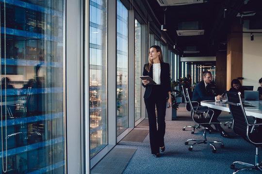 modern professional woman confidently walking into an office building