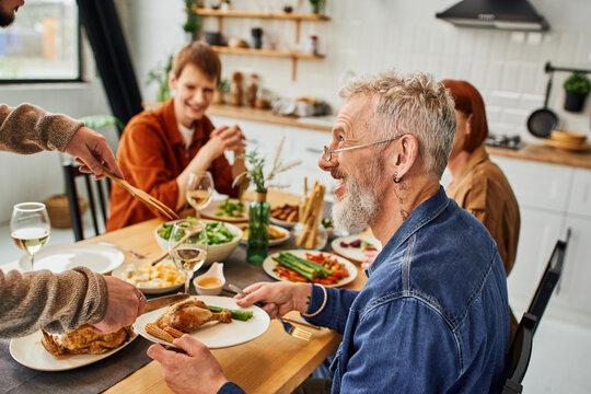 Smiling family enjoying dinner, crispy chicken thighs on plates