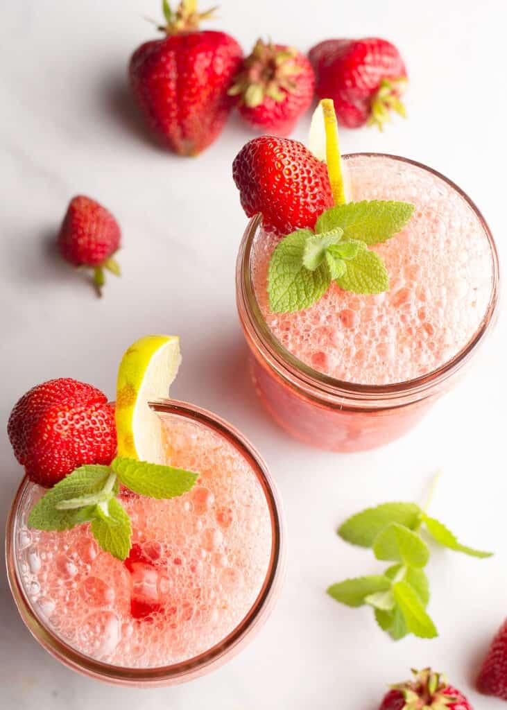 glasses of strawberry mint refresher garnished with strawberries and mint