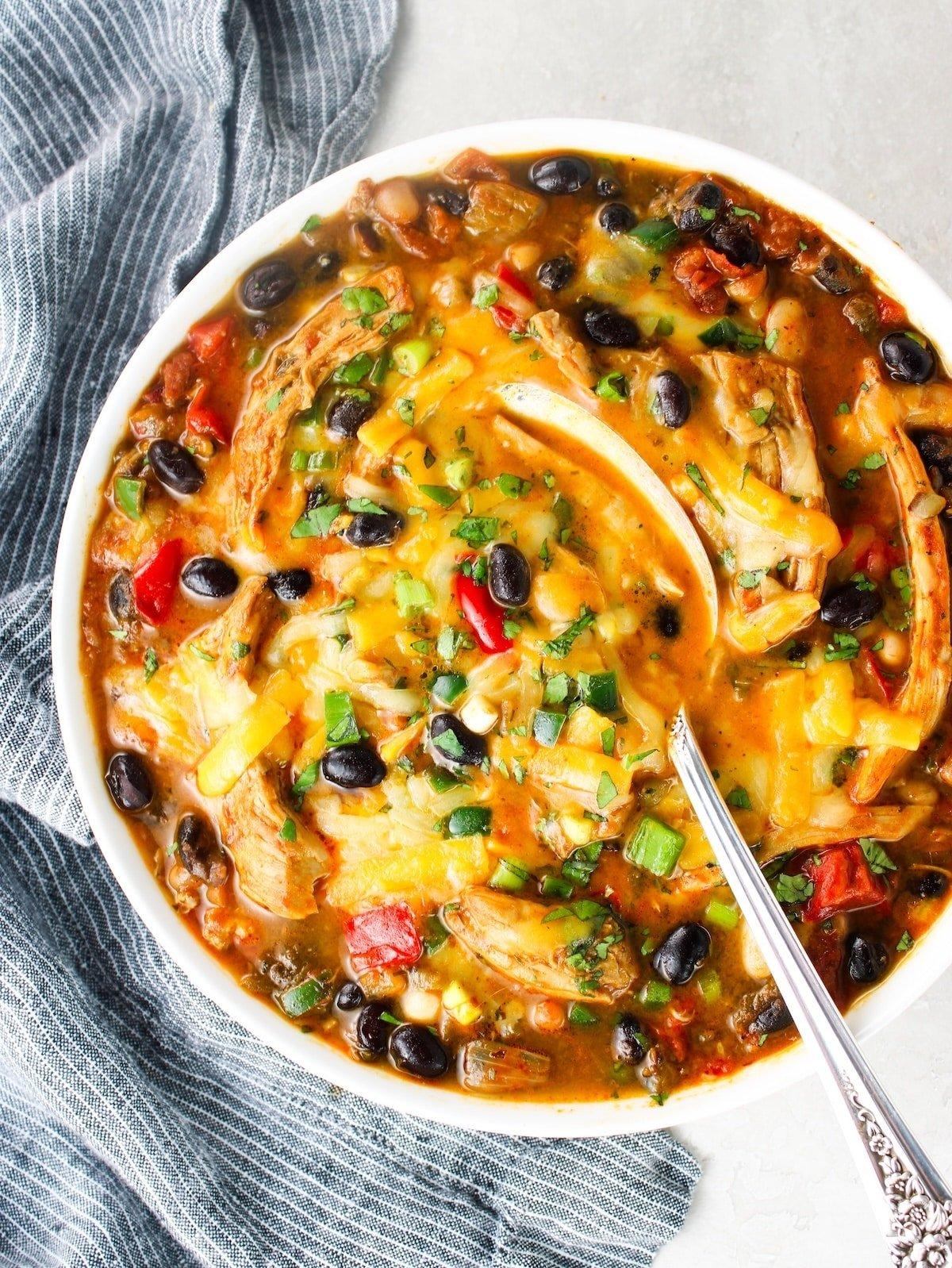 hearty smoky chicken chili pot bake on a rustic table, cozy warm lighting