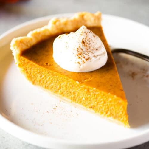 sliced pumpkin pie showing distinct custard layer