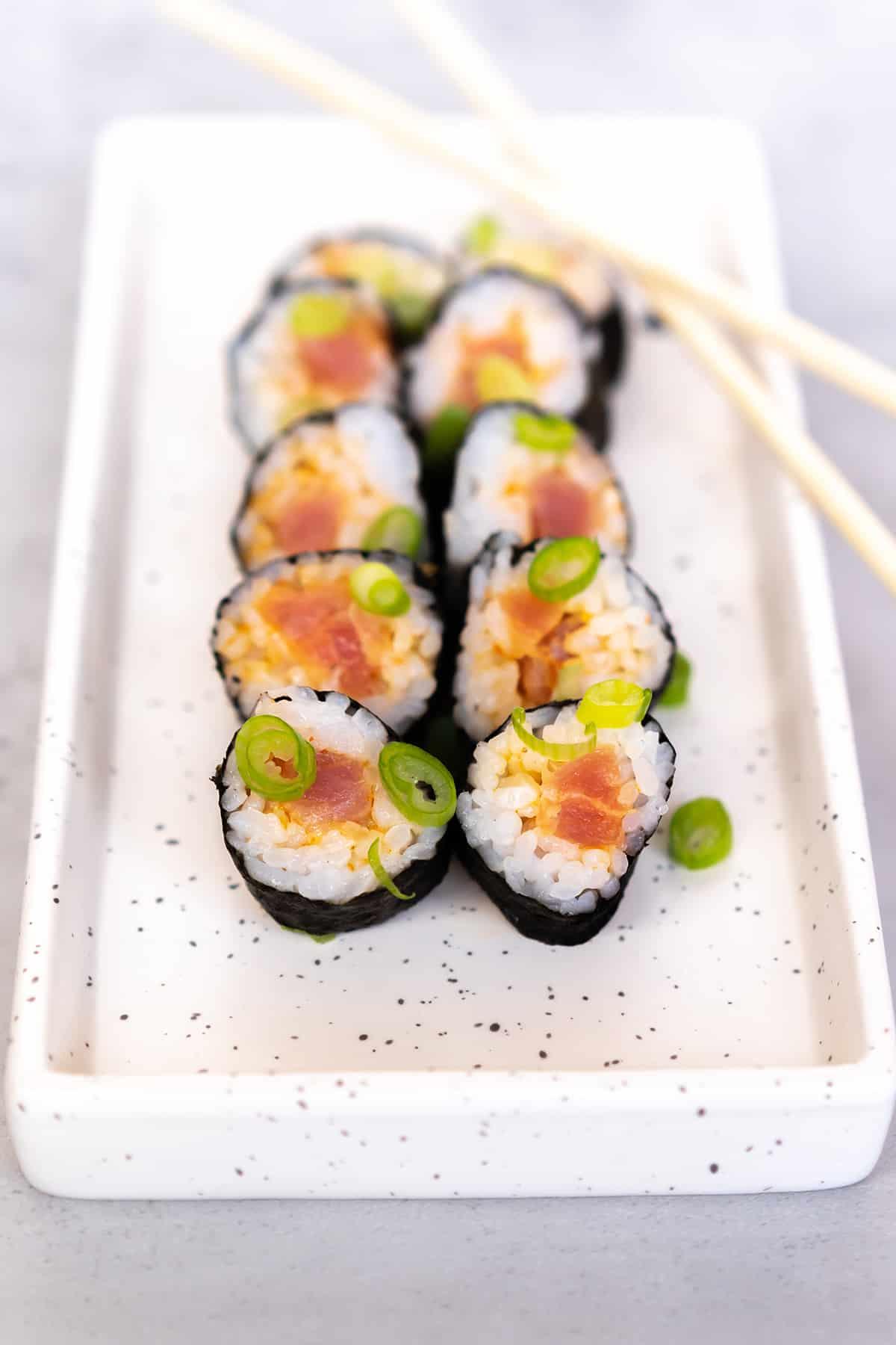 ingredients for spicy tuna roll, including tuna, avocado, spicy mayo, and sushi rice