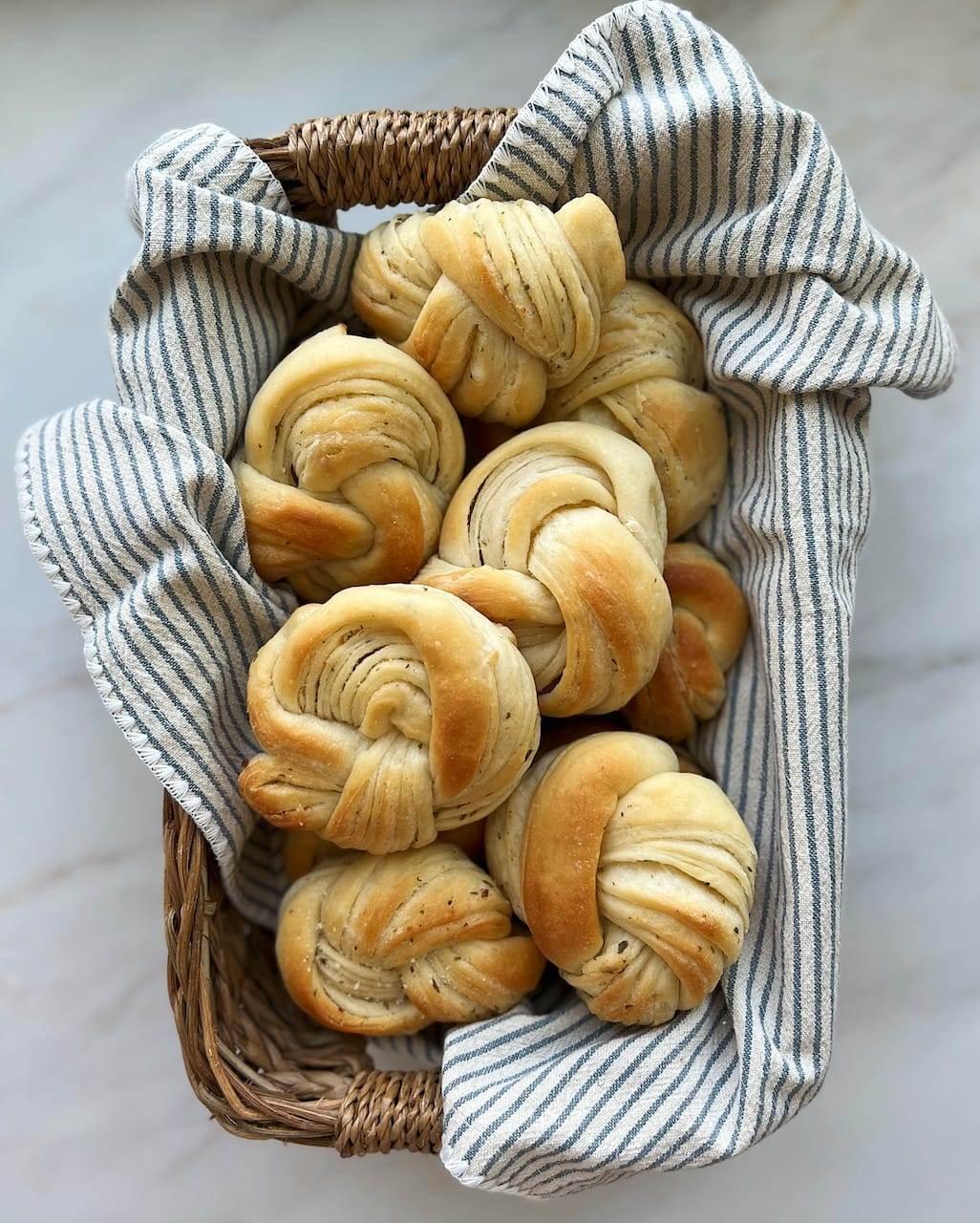Close-up of golden brown garlic knots fresh out of the oven, steam gently rising