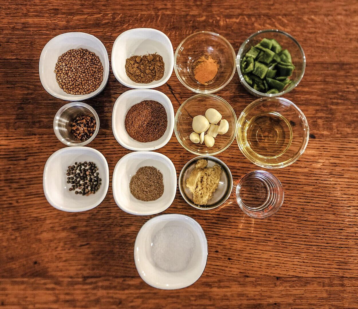 Overhead view of various spices used in Chicken Tikka Masala