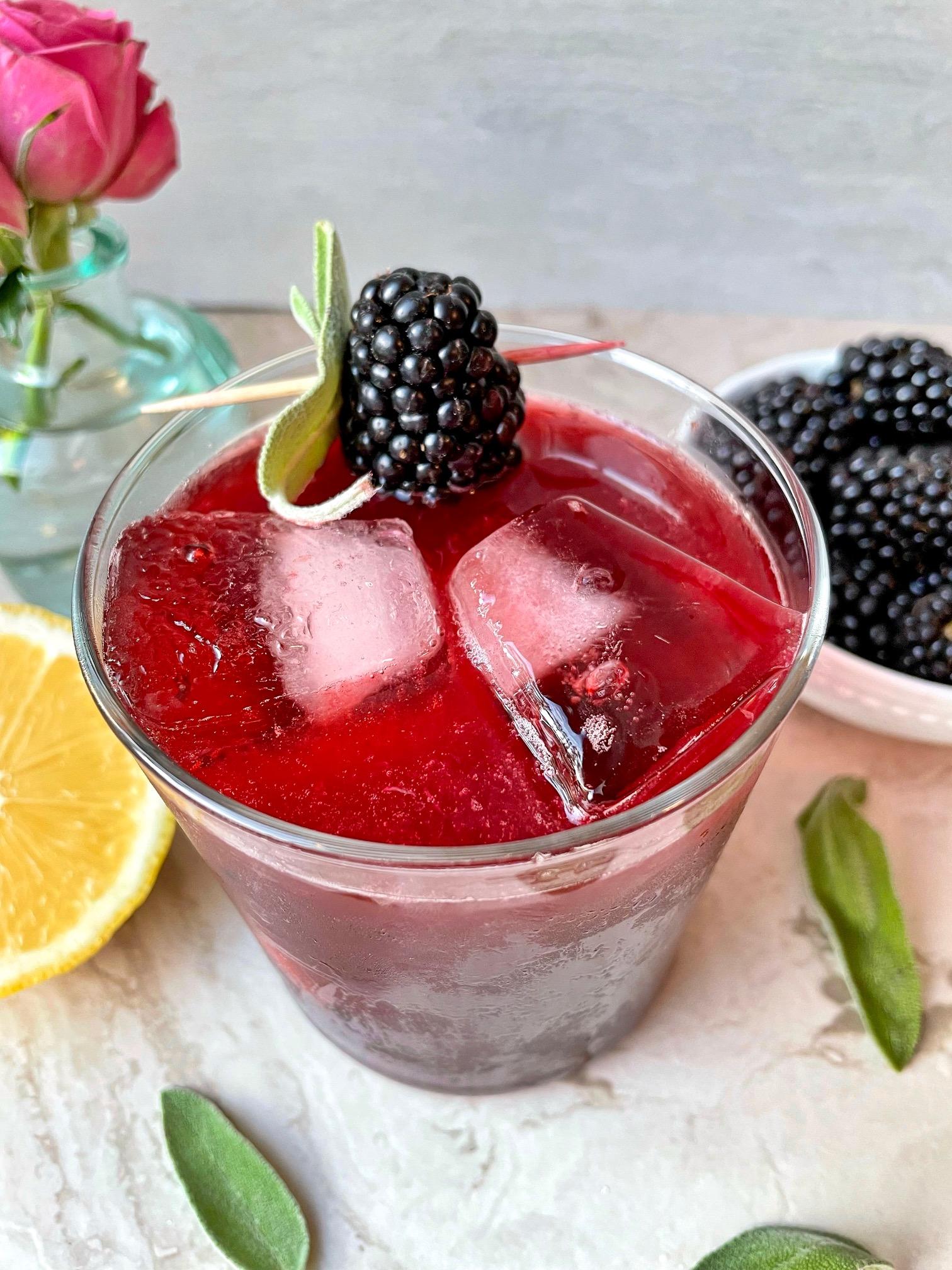 close-up shot of blackberries and sage leaves