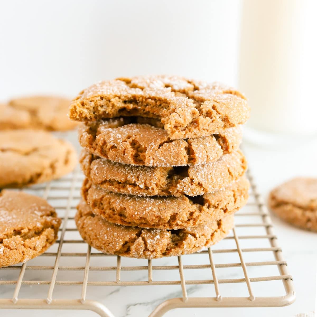 warm molasses cookies with crinkled tops on a cooling rack, cozy kitchen background