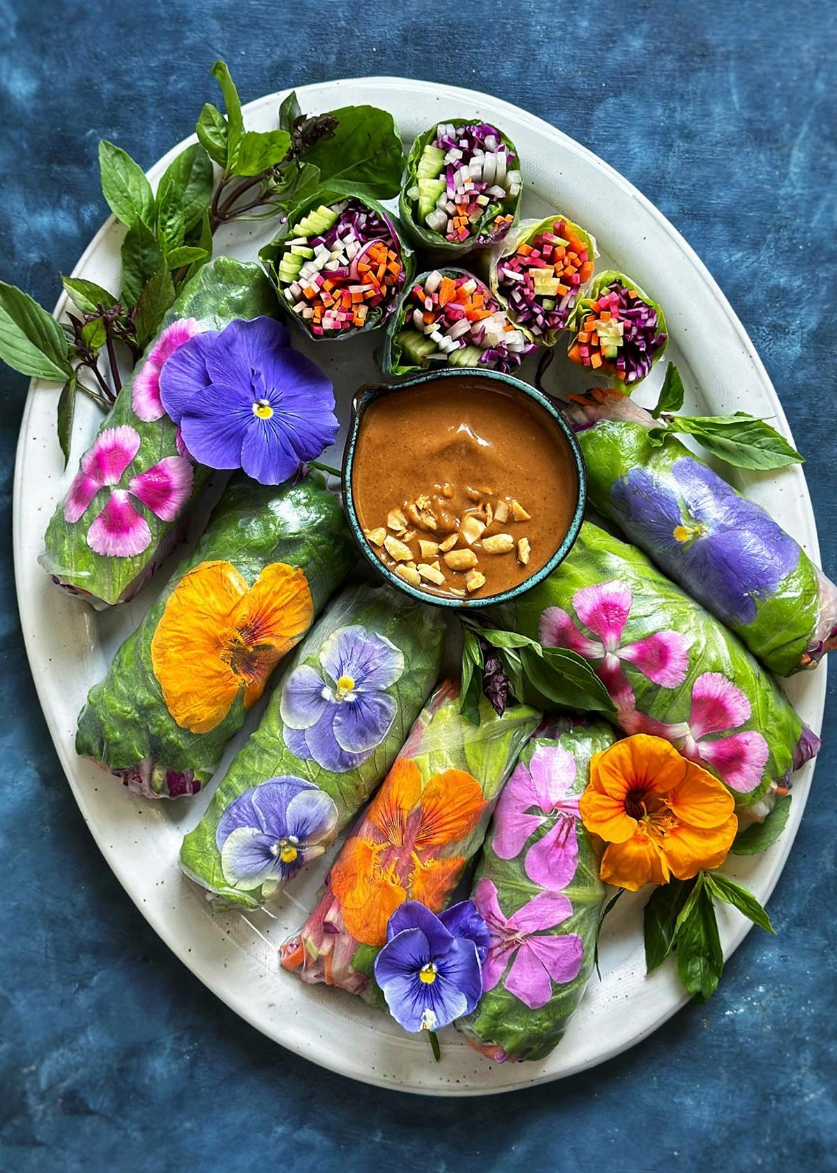ingredients for asian spring rolls laid out on a wooden surface