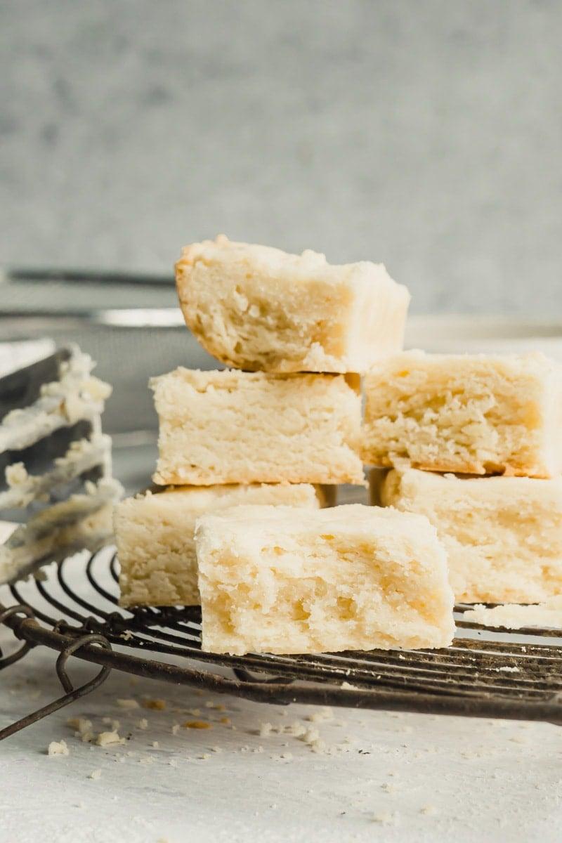 Grandma's hands carefully placing a warm shortbread cookie onto a cooling rack, gentle focus