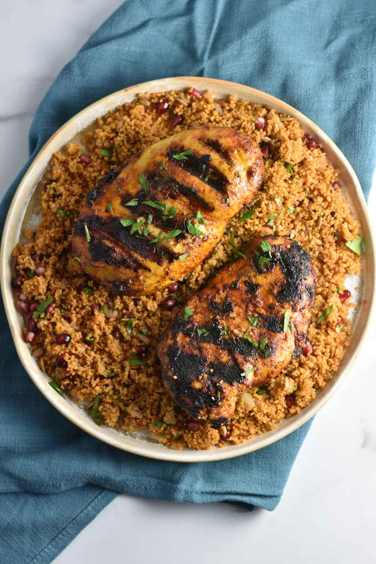 close up shot of grilled chicken and couscous salad