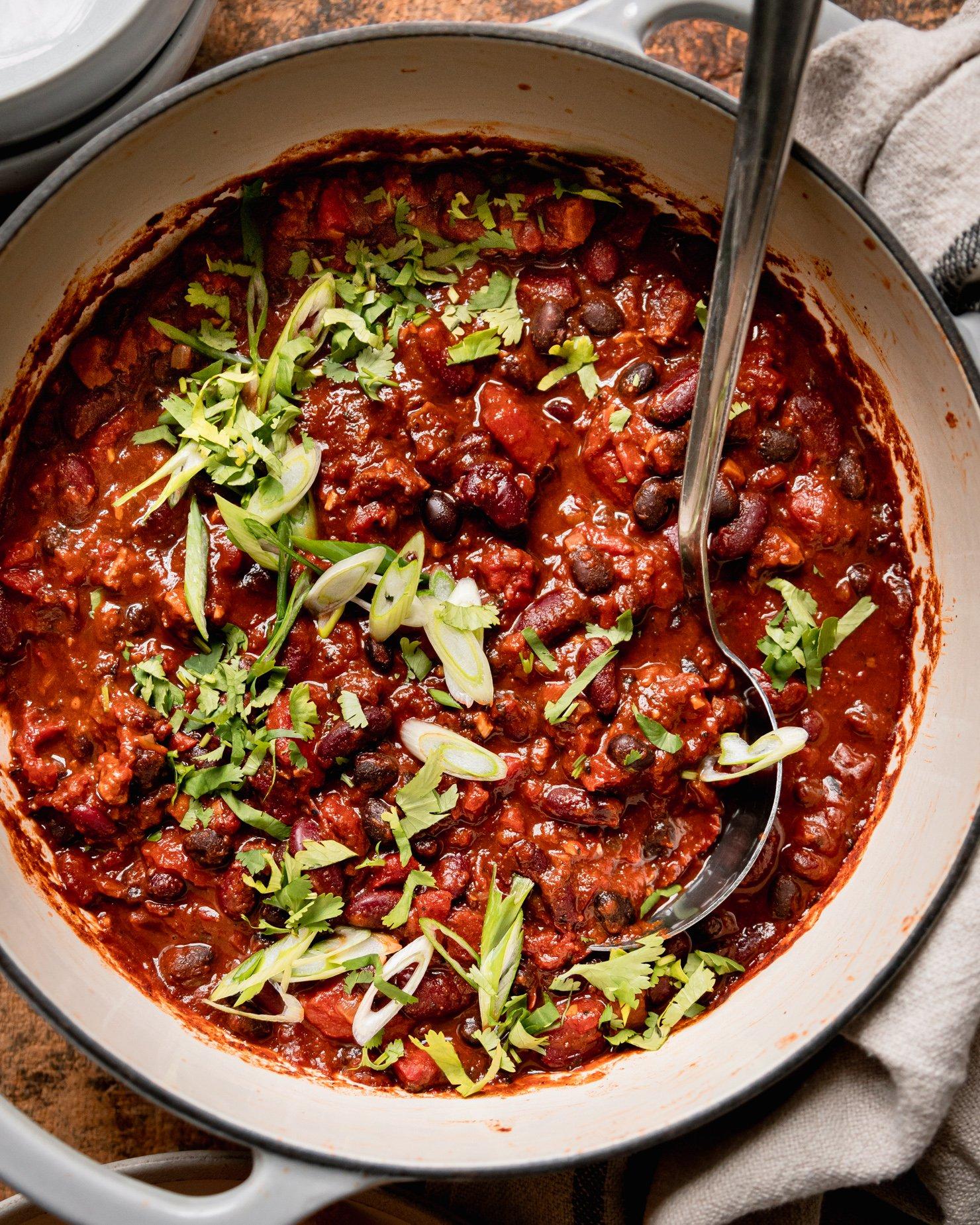 close-up shot of vegan chili simmering in a pot on the stove